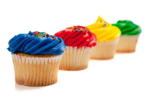 Rainbow colored cupcakes Stock Photos