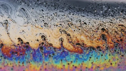 Rainbow colored liquid background in motion Stock Footage 133697379