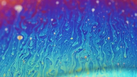 Rainbow colored liquid background in motion Stock Footage 133697496
