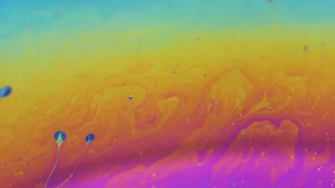 Rainbow colored liquid background in motion Stock Footage 133697736