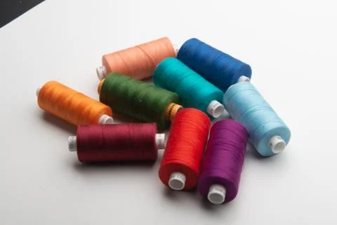 Rainbow colored sewing thread lined Stock Photos