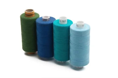 Rainbow colored sewing thread lined Stock Photos