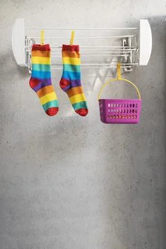 Rainbow colored socks lying on a clothesline. LGBT Concept Stock Photos