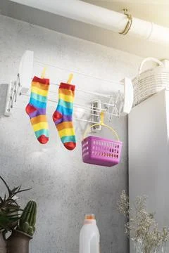 Rainbow colored socks lying in a laundry room. LGBT Concept Stock Photos