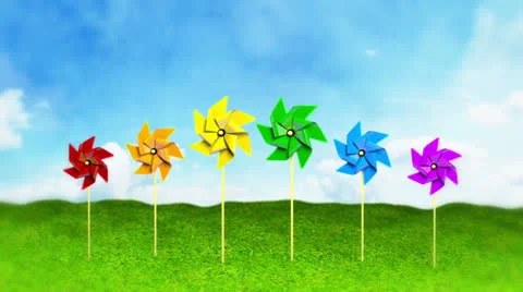 Rainbow Colored Spinning Pinwheels on Grass Stock Footage 27196316