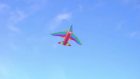 A rainbow colored stunt kite in the blue sky Stock Footage 132535040