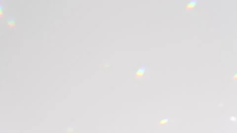 Rainbow-colored sunbeams move against a gray concrete wall Stock Footage 172479210