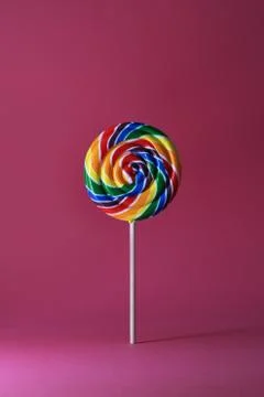 Rainbow colorful lollipop isolated on pink background Stock Photos