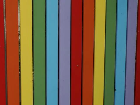 Rainbow colors multicolor vertical pattern painted fence Stock Photos