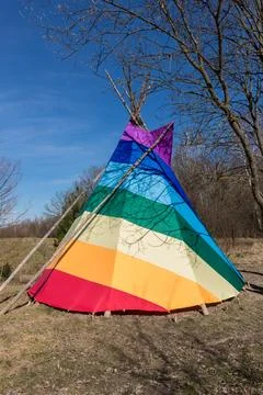 Rainbow-coloured tepee set up in the garden, early spring, traditional Indian Stock Photos
