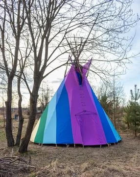 Rainbow-coloured tepee set up in the garden, early spring, traditional Indian Stock Photos