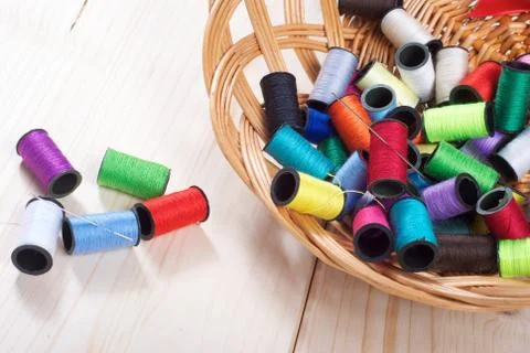 Rainbow of colourful thread spools on the table Stock Photos