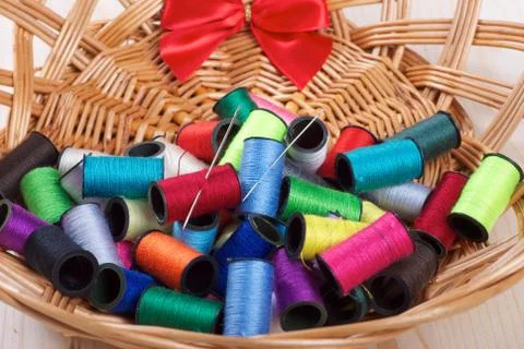 Rainbow of colourful thread spools on the table Stock Photos
