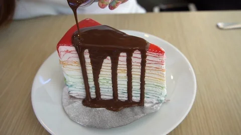 Rainbow crape cake with chocolate sauce. Video stock 101277721