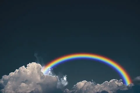Rainbow on the dark cloud on the sky Stock Photos