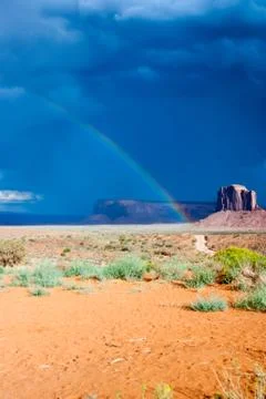 Rainbow on a dark desert Stock Photos