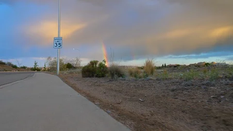 Rainbow in Distance Walking Sidewalk Stock Footage 112940313