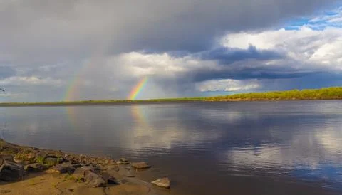 Rainbow double over the river Stock Photos