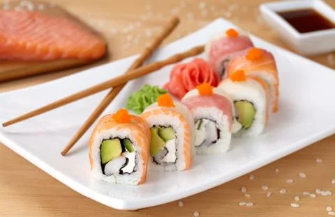 Rainbow dragon sushi roll with salmon, avocado, soft cheese, cucumber and tobiko Stock Photos