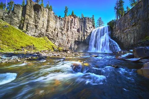 Rainbow Falls Waterfall and Devils Postpile Cliffs with Flowing River in Stock Photos