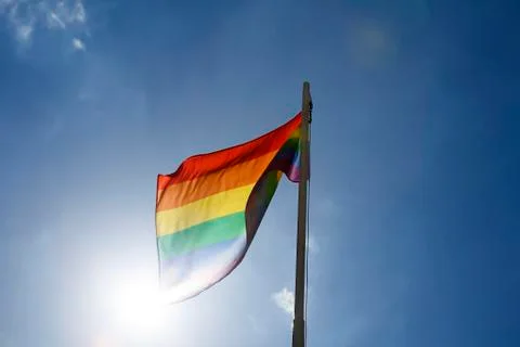 Rainbow flag on a flagpole Stock Photos