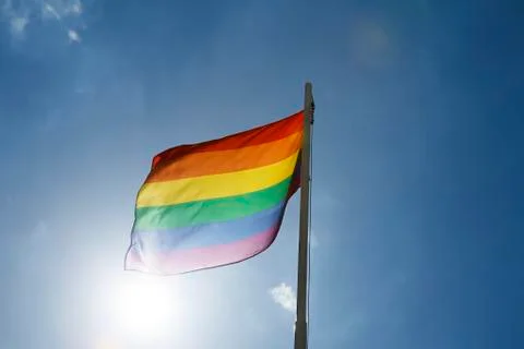 Rainbow flag on a flagpole Stock Photos