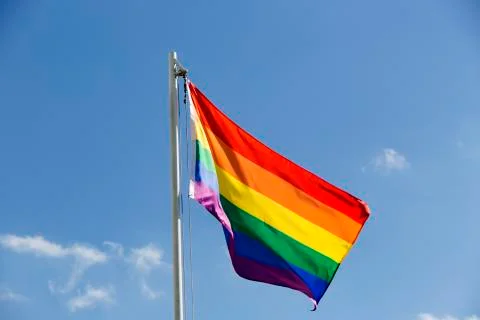 Rainbow flag on a flagpole Stock Photos