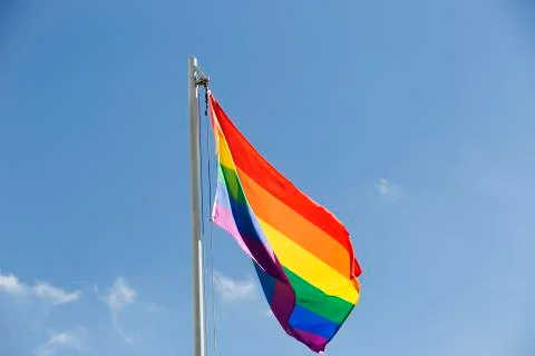 Rainbow flag on a flagpole Stock Photos
