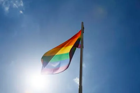 Rainbow flag on a flagpole Stock Photos