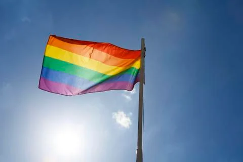 Rainbow flag on a flagpole Stock Photos