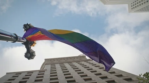 A rainbow flag flies in front of city buildings and a US flag. San Francisco, Stock Footage 92824338