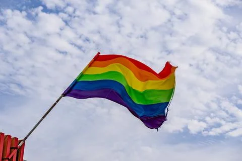 A rainbow flag is flying in the sky Stock Photos