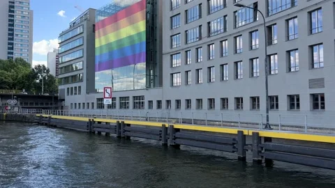 The rainbow flag on the Humboldt Forum building. View from Spree river in Berlin Stock Footage 199040622