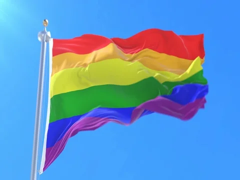The rainbow flag, LGBT pride flag or gay pride flag waving at wind, loop Stock Footage 80368775
