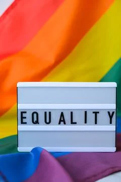 Rainbow flag with lightbox and text EQUALITY. Rainbow lgbtq flag made from silk Stock Photos