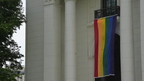 Rainbow flag. Pride flag hanging at a balcony of a museum Stock Footage 340048670