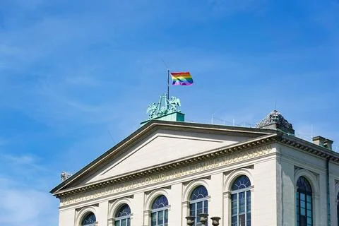 Rainbow flag raised on top of opera house in Hannover during pride month Stock Photos