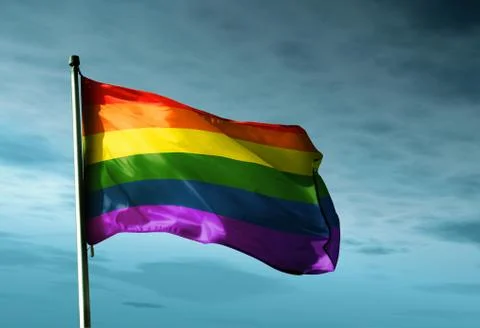 Rainbow flag waving in the evening Stock Illustration