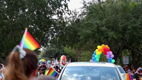 Rainbow Flags and a Balloon Arch Car at the Jacksonville Pride Parade Stock Footage 346920088