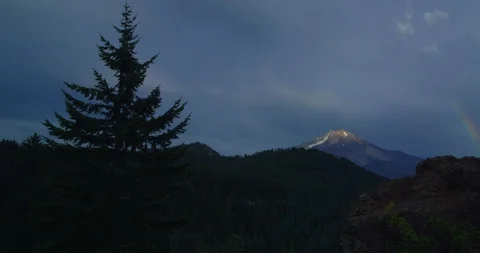 A rainbow foreshadows a break in a storm over Mt. Jefferson, OR Stock Footage 127738165