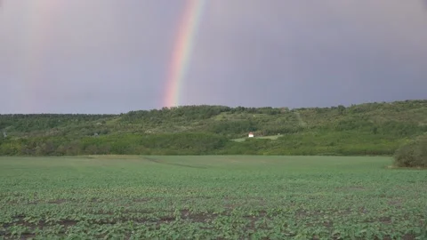 Rainbow in the forest above the small chapel Stock Footage 148203202