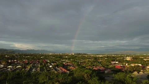 Rainbow in forest with rural dwellings Stock Footage 220086886