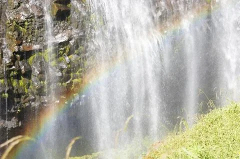 Rainbow formed under narada falls Stock Photos