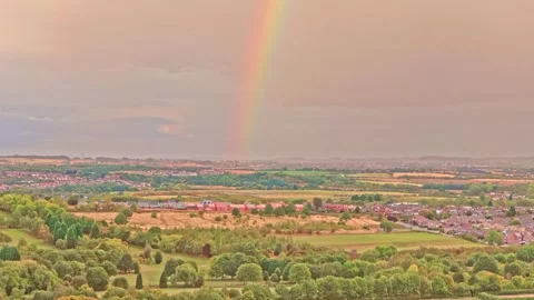 Rainbow forms over Hemingfield and Barnsley countryside, UK with patchwork Video stock 321516907