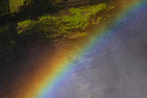 A rainbow forms at the top of a waterfall at Letchworth State Park Stock Photos