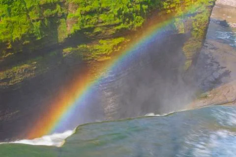 A rainbow forms at the top of a waterfall at Letchworth State Park Stock Photos