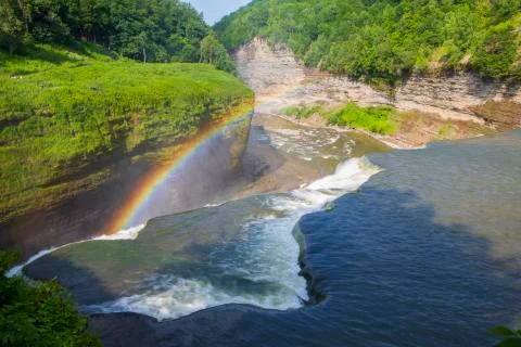 A rainbow forms at the top of a waterfall at Letchworth State Park Stock Photos