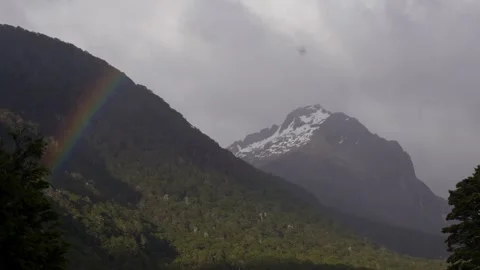 Rainbow in front of snowy mountain Vídeos de archivo 327764641