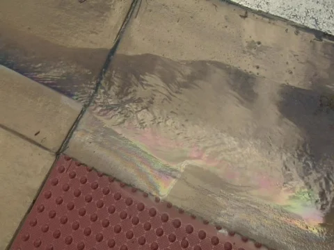 A rainbow of gasoline runoff pollution Video stock 609778