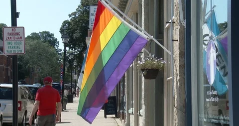 Rainbow Gay Pride Flag in Front of Business - Small Town Main Street Stock Footage 93631362
